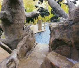 custom rock feature with pool in background
