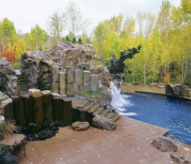 custom rock feature with waterfall flowing into a pool